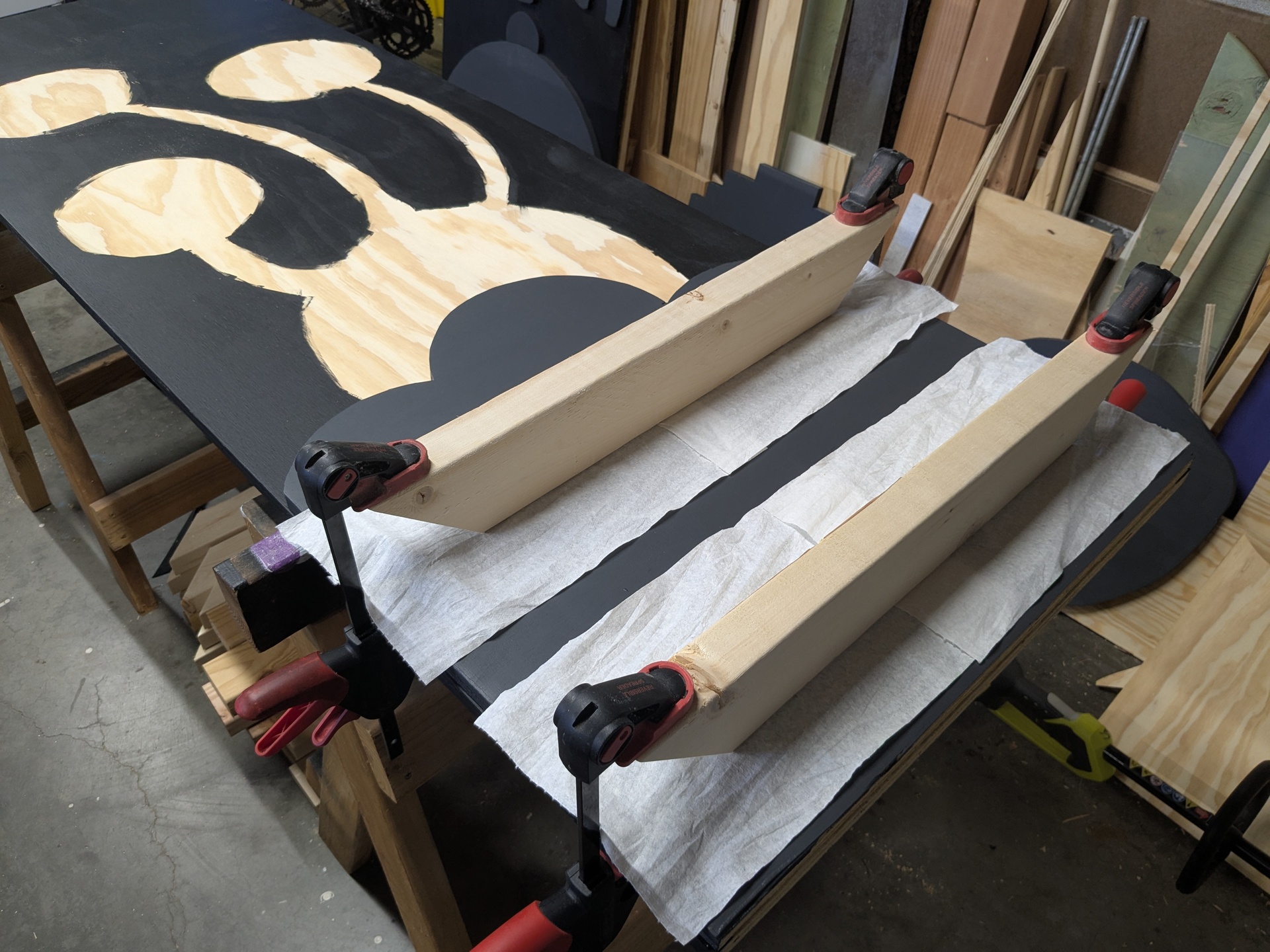 The paper towels kept the clamping boards from sticking to the paint First layer pieces getting clamped onto the backgrounds